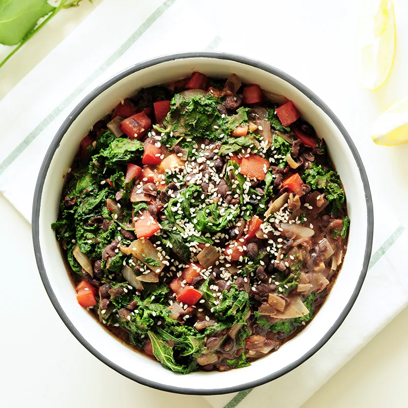 Warm black bean, kale and tomato salad
